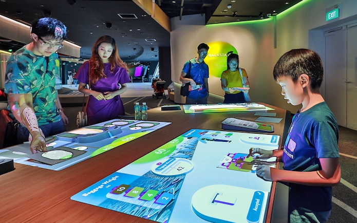 Visitors interacting with digital exhibits at Petrosains, Kuala Lumpur.