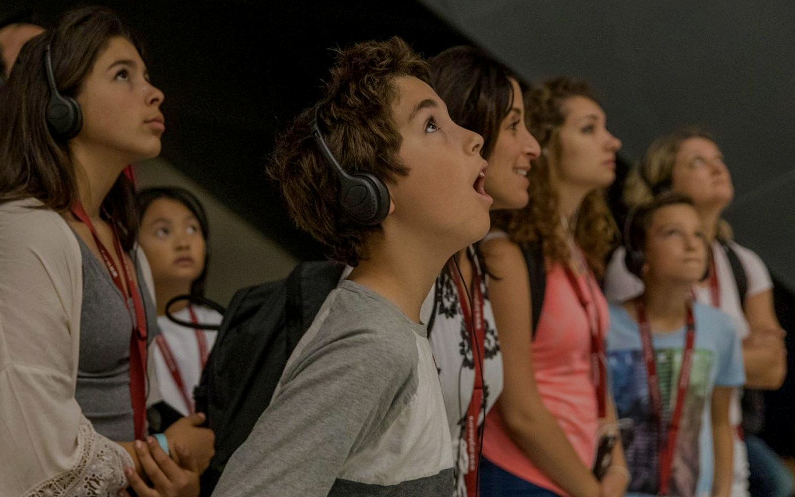 Visitors using audio guides during a museum tour.