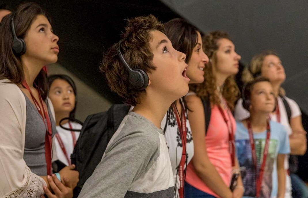 tourist using audio guide at historical site in rome italy