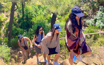 Guests hiking up a forested trail on Princess Island.