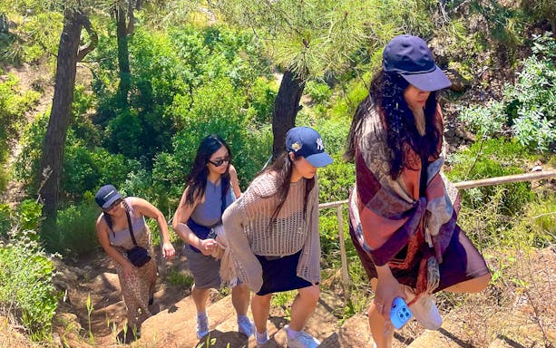 Guests hiking up a forested trail on Princess Island.
