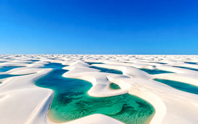 Sand dunes and turquoise lagoons at Lagoa Bonita, Barreirinhas, Brazil.