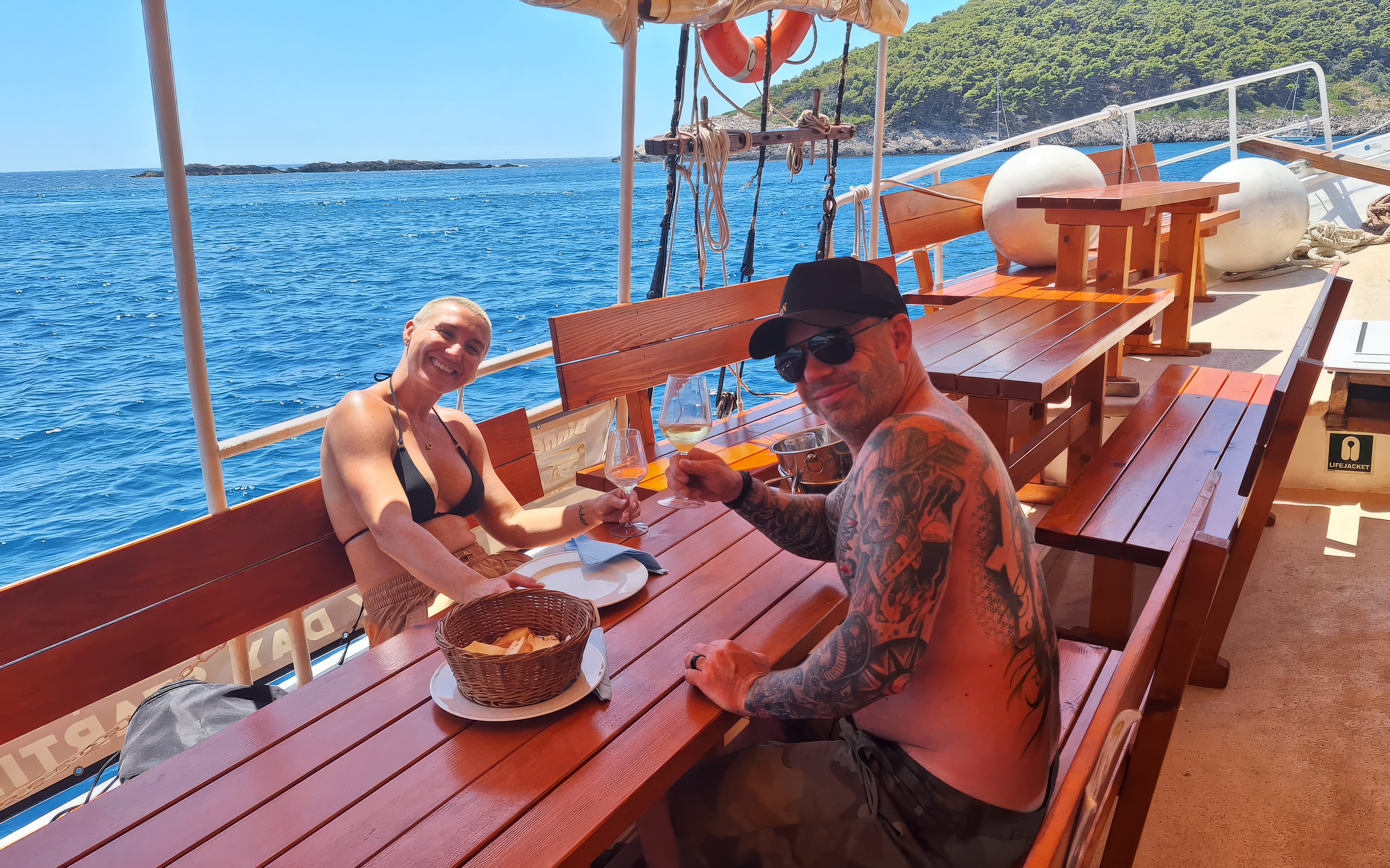 Couple having lunch on a boat with sea view in Dubrovnik.