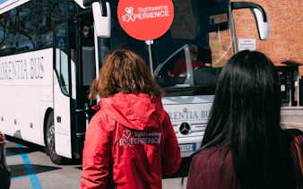 Tourists boarding a sightseeing bus for the Chianti Half Day Tour from Florence.