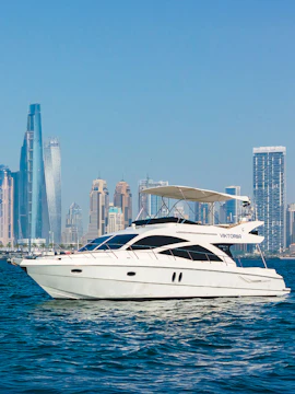 Viktoriia luxury yacht cruising with Dubai skyline in the background.