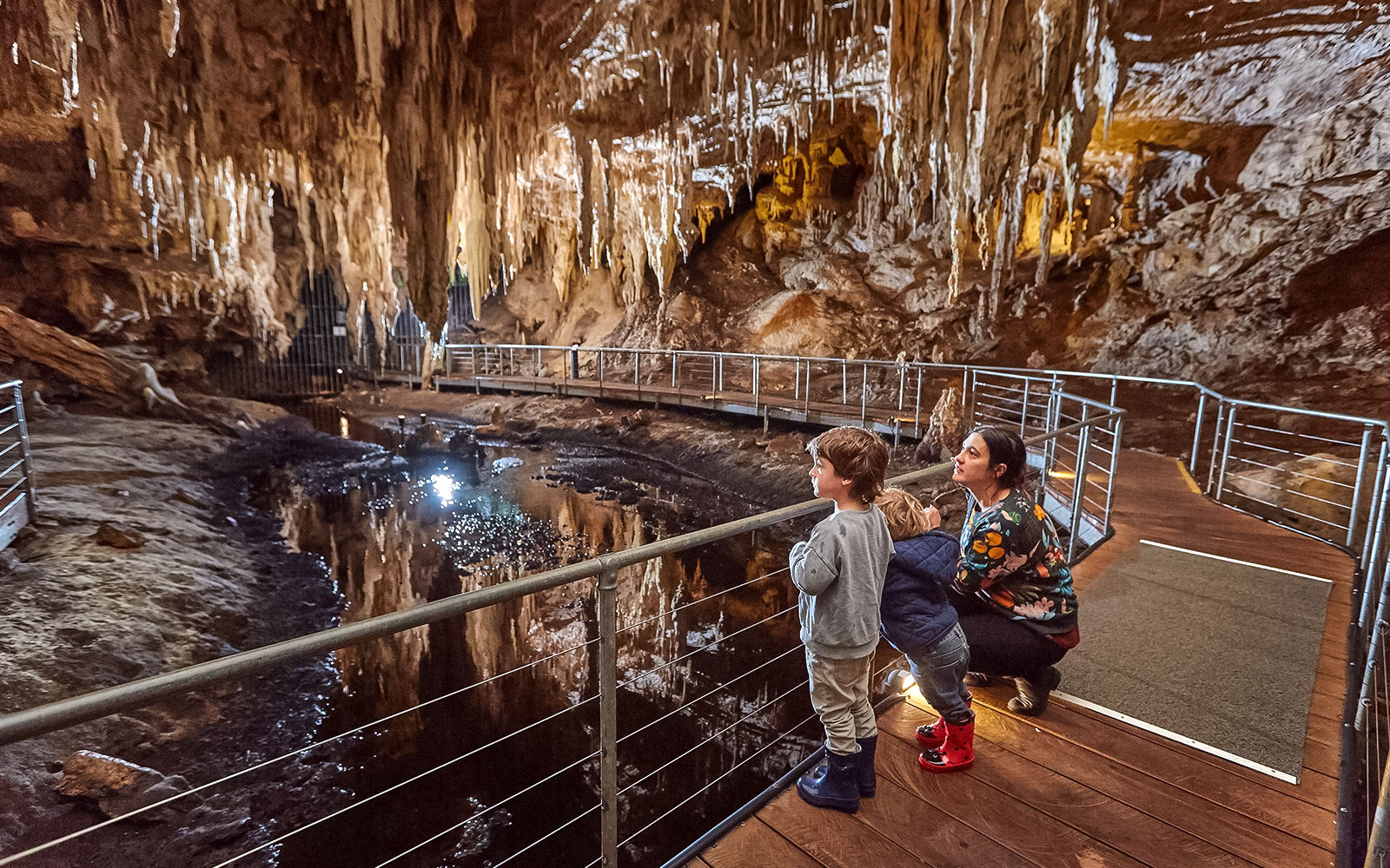 Family exploring Mammoth Cave on a self-guided audio tour in Margaret River.