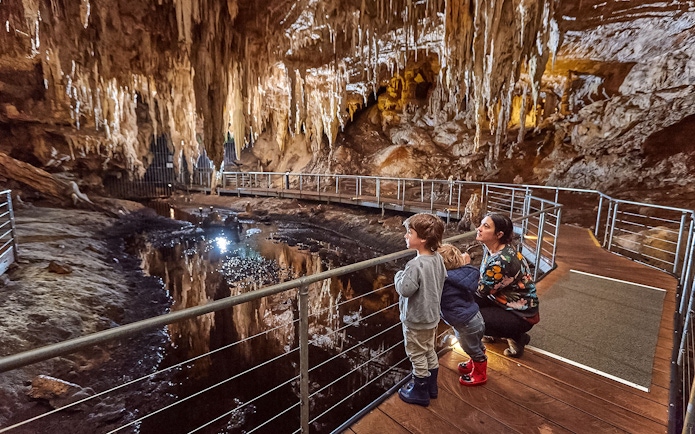 Family exploring Mammoth Cave on a self-guided audio tour in Margaret River.
