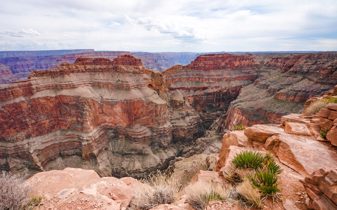 Helicopter landing site inside Grand Canyon West with layered rock formations.