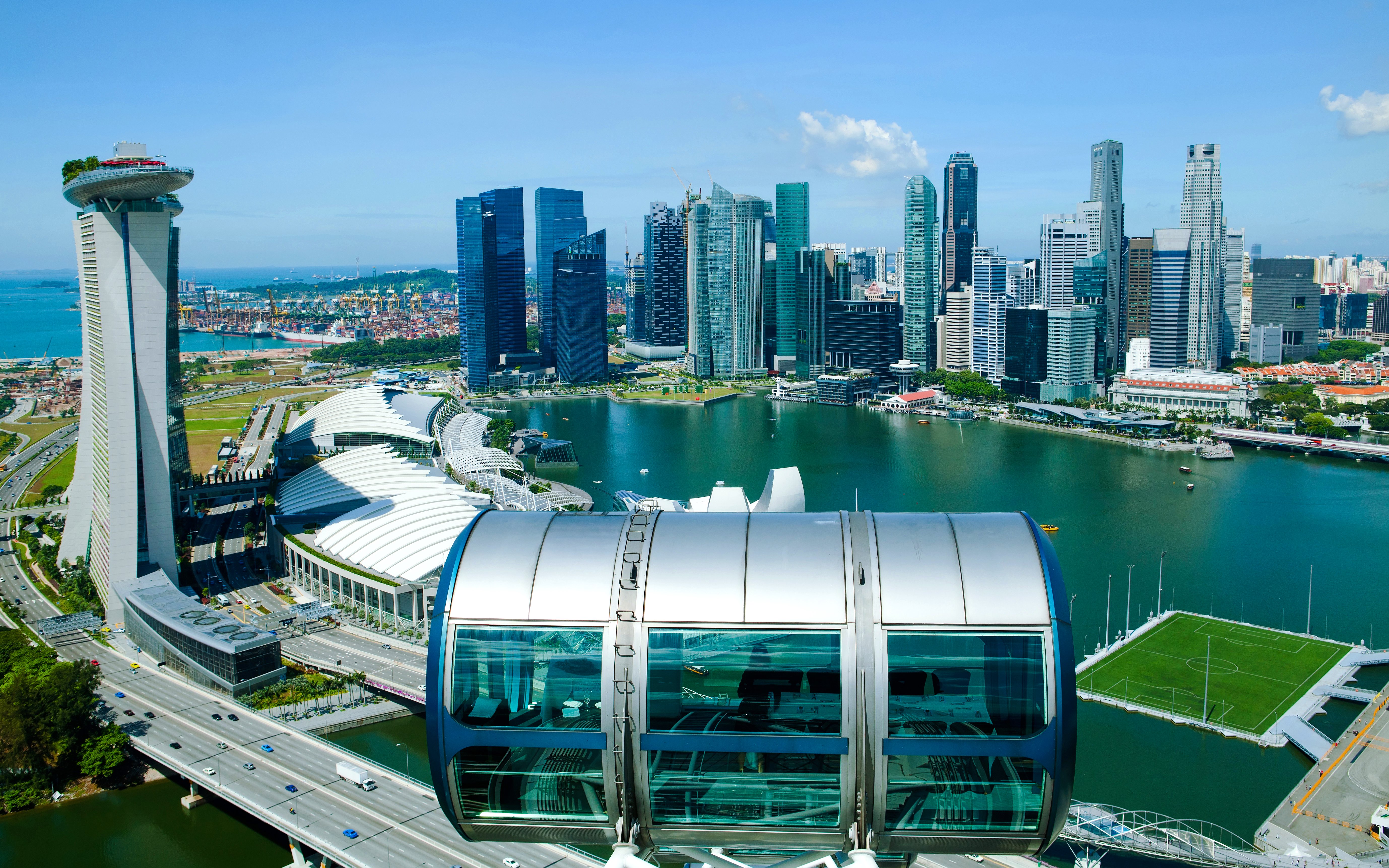 Singapore Flyer capsule overlooking Marina Bay and city skyline.