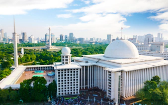 Istiqlal Mosque and National Monument in Jakarta skyline.