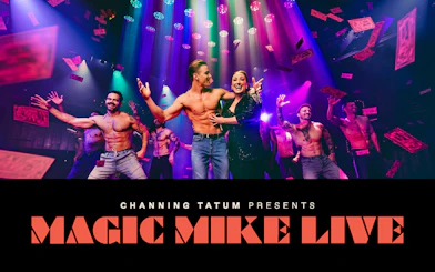 Performers on stage at Magic Mike Live show with colorful lights and confetti.
