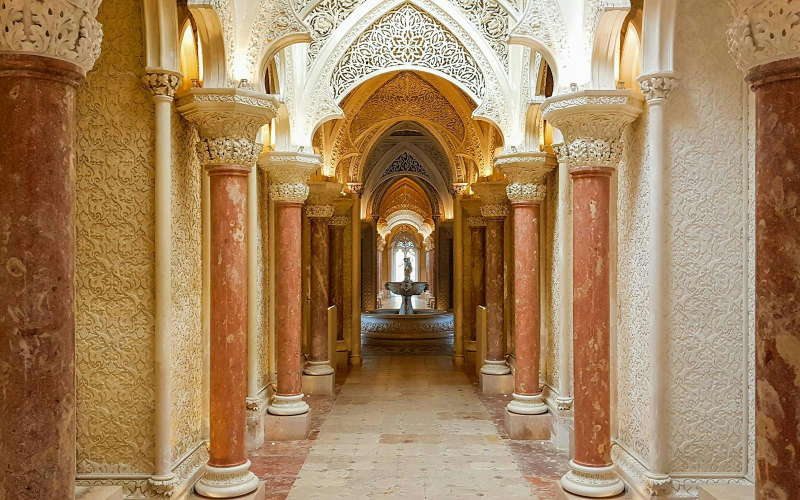 Halls of arches with intricate carvings at Monserrate Palace, Sintra, Portugal.