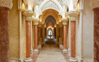 Halls of arches with intricate carvings at Monserrate Palace, Sintra, Portugal.