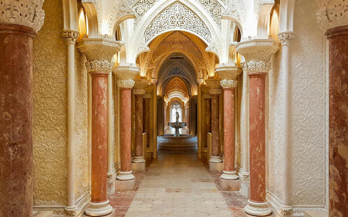 Halls of arches with intricate carvings at Monserrate Palace, Sintra, Portugal.
