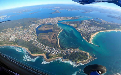 Aerial view of Newcastle coastline and waterways during tandem skydiving in Australia.