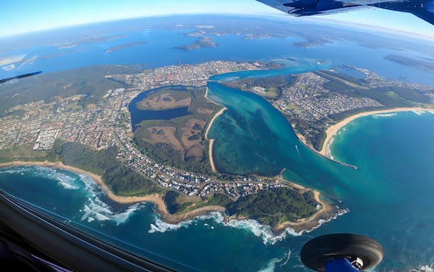 Aerial view of Newcastle coastline and waterways during tandem skydiving in Australia.