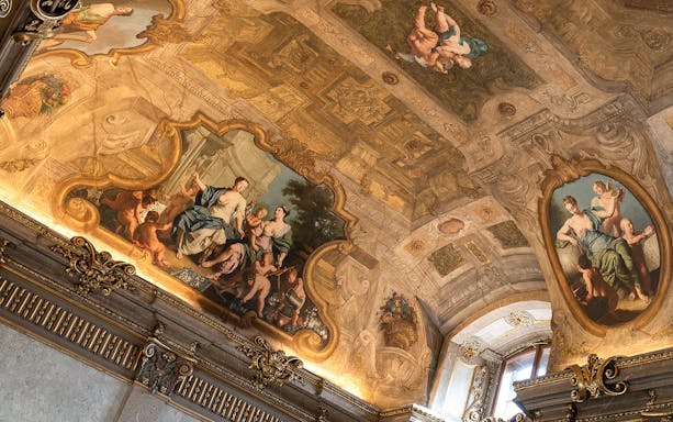 Palais Lobkowitz ornate ceiling frescoes with classical figures, Vienna audio guide tour.
