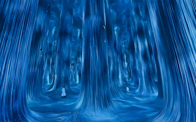 Immersive digital art installation at TeamLab Phenomena Abu Dhabi with flowing blue lights.