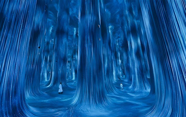 Immersive digital art installation at TeamLab Phenomena Abu Dhabi with flowing blue lights.