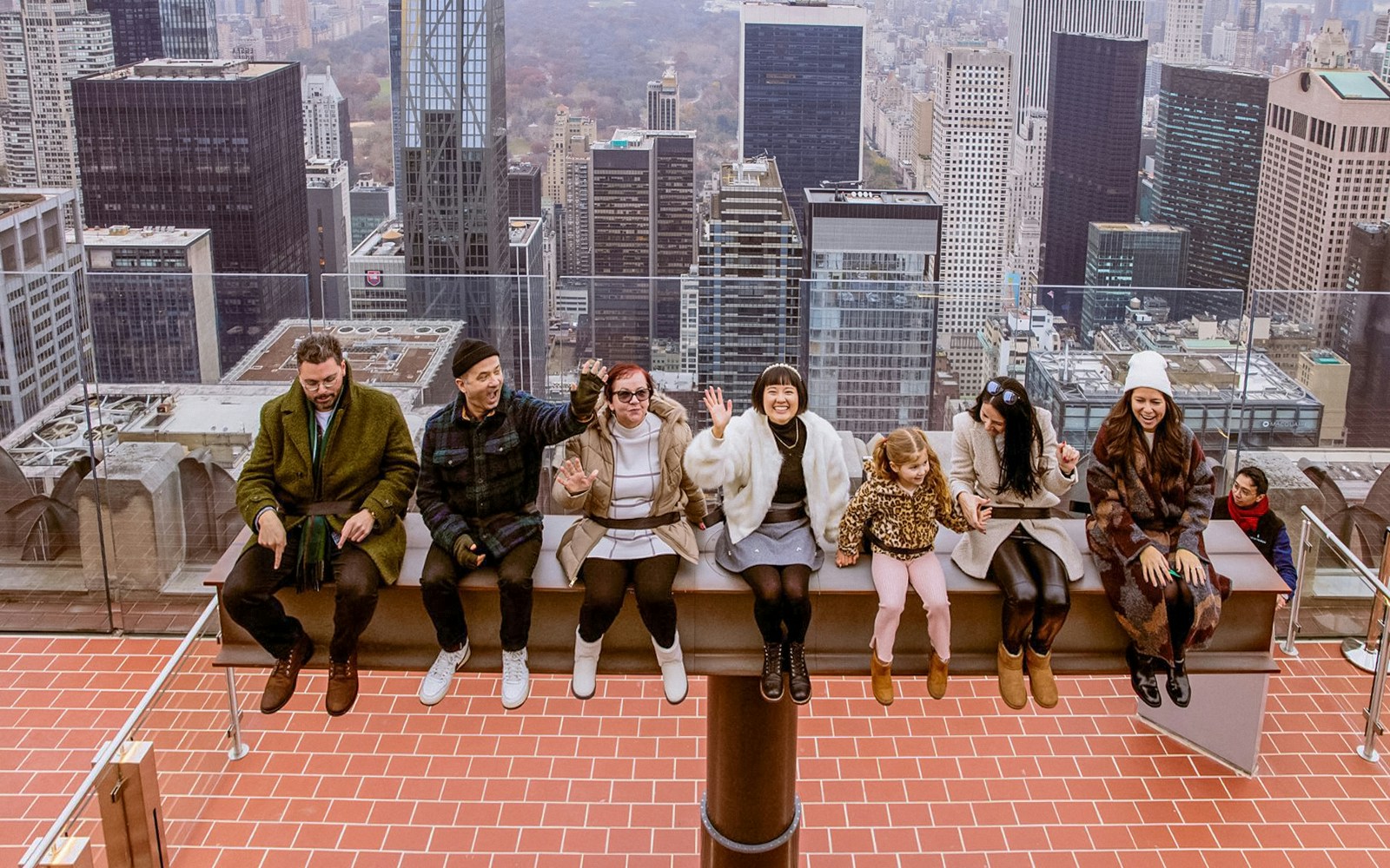 People sitting on The Beam, Top of the Rock, Rockefeller Center, New York