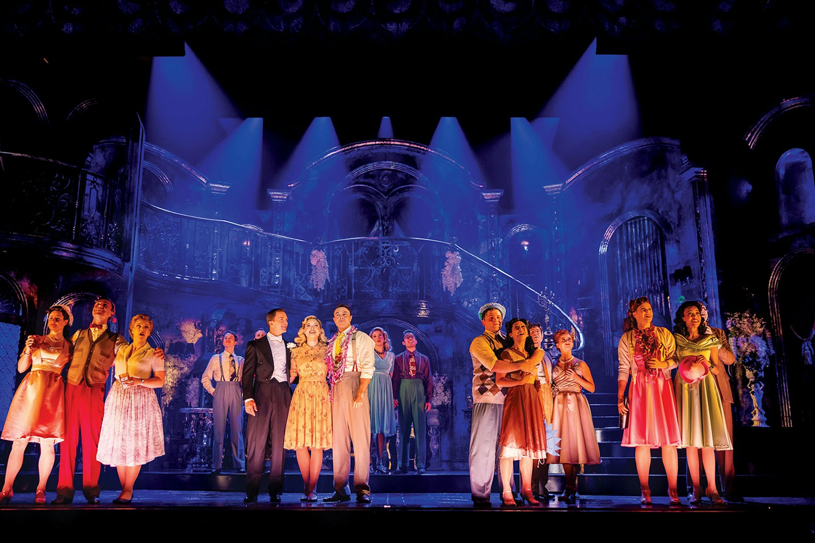 Theater performance on Sunset Boulevard stage with actors in vintage attire.
