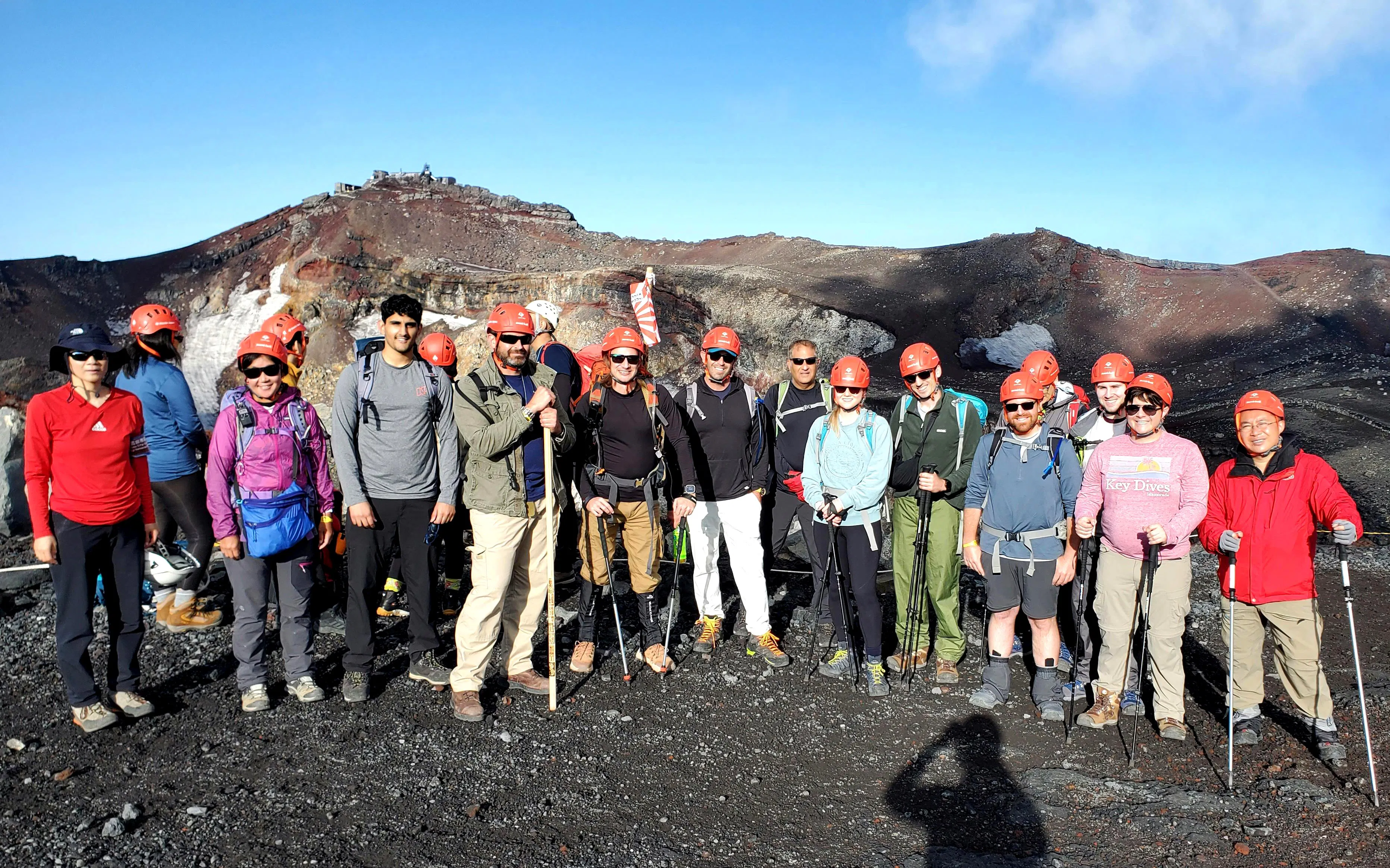 Group of hikers with helmets on Mt. Fuji climbing tour, Japan.