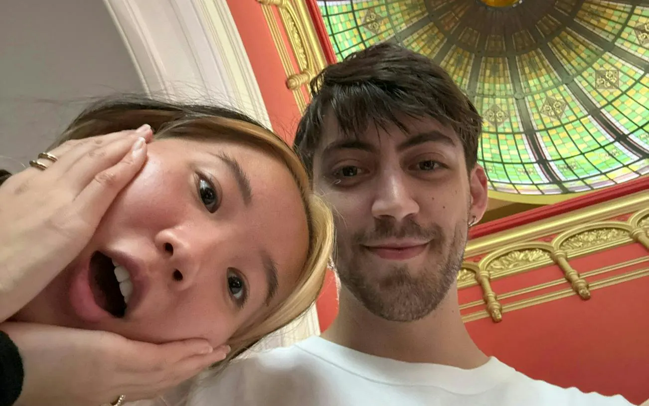 Visitors inside Sydney's Queen Victoria Building, exploring the stained glass dome.