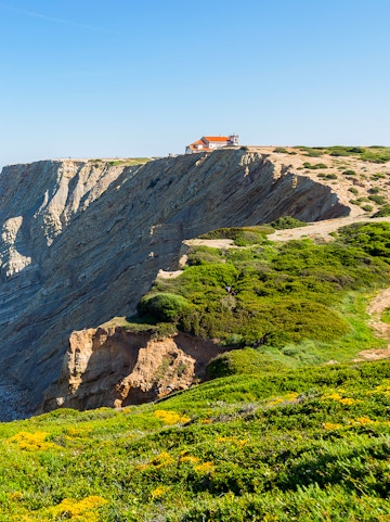 Cliffside view with a chapel at Arrabida Natural Park, Portugal.