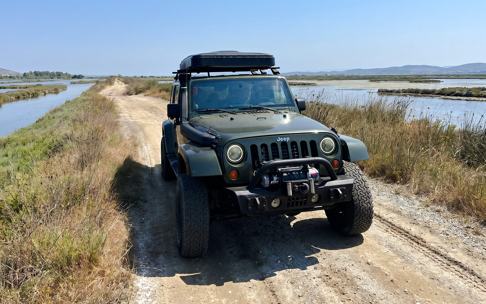 4X4 Jeep on dirt path near Karavasta Lagoon.