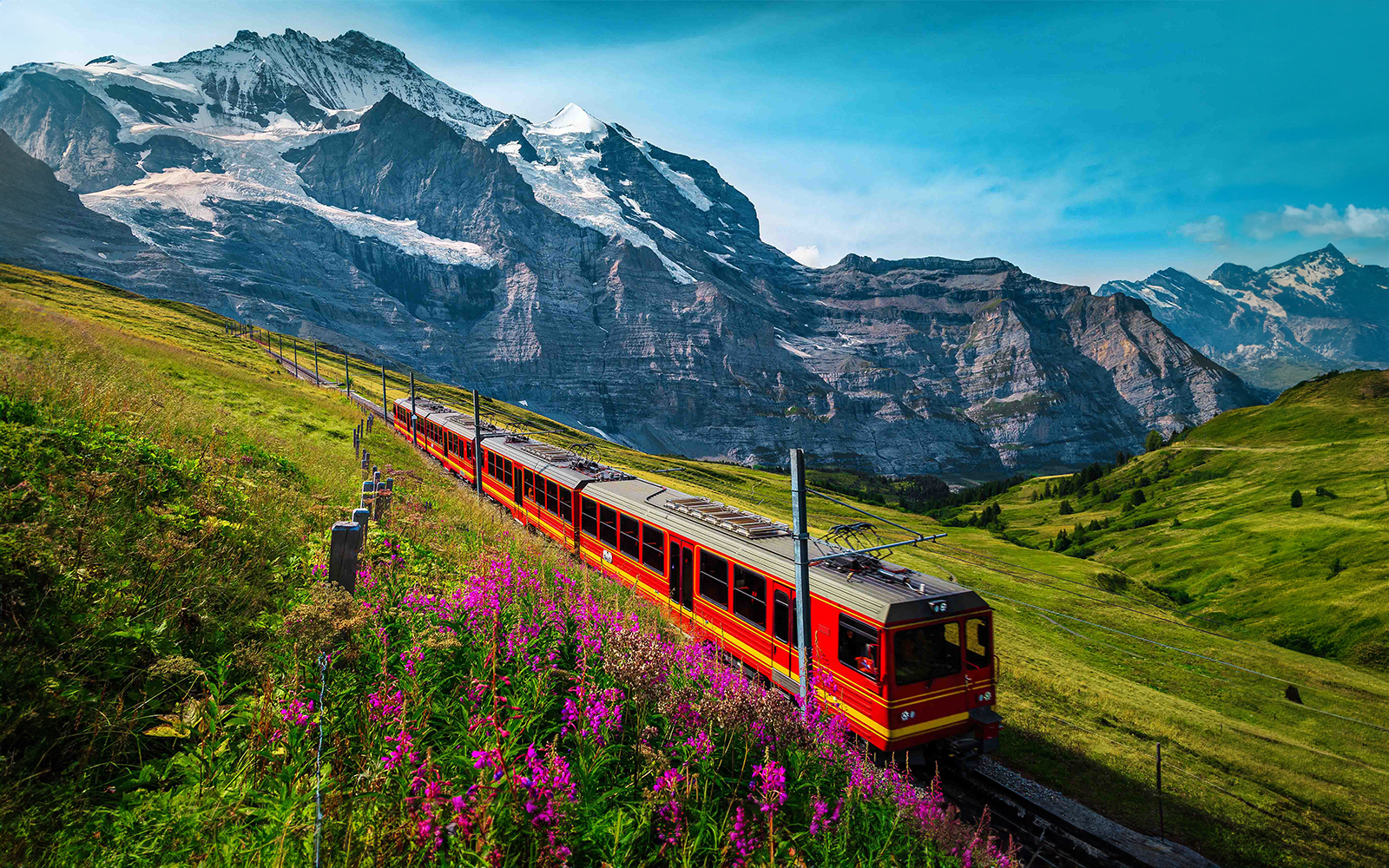Train traveling through alpine landscape towards Jungfraujoch, Switzerland.