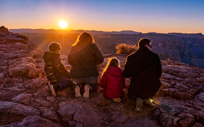 Family watching sunset at Grand Canyon West.
