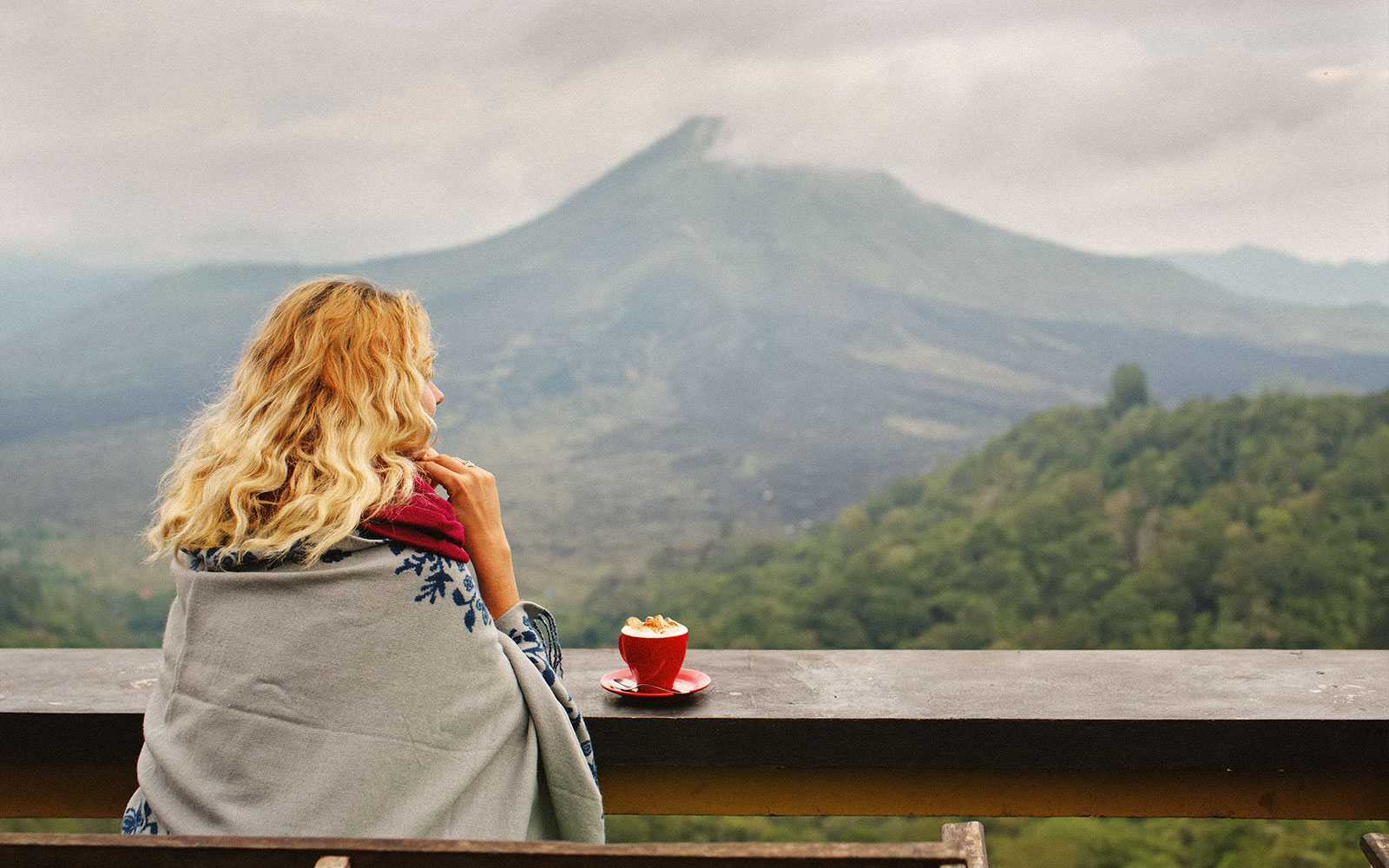 Woman enjoying coffee with view of mount batur