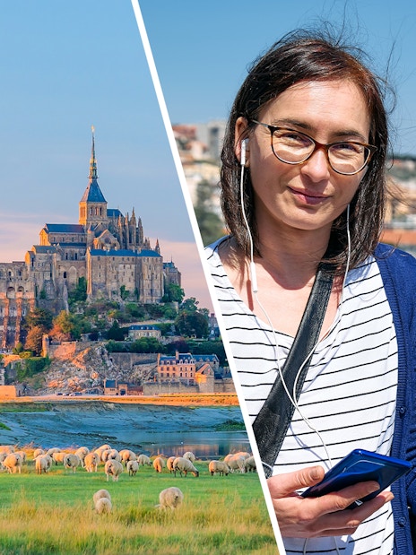 Mont Saint-Michel with abbey and visitor using audio guide.