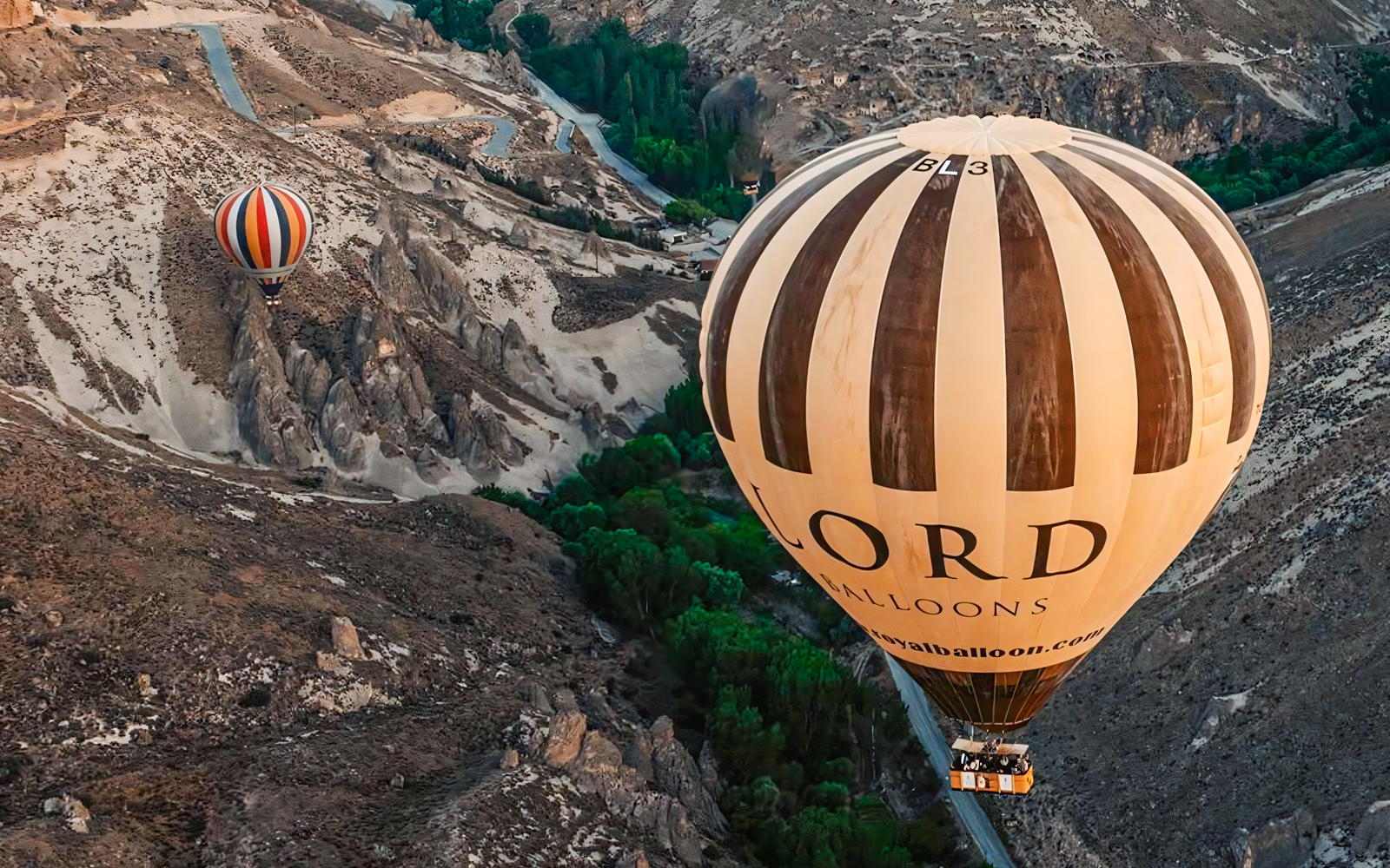 Two hot air balloons floating over Soganli Valley in Cappadocia.