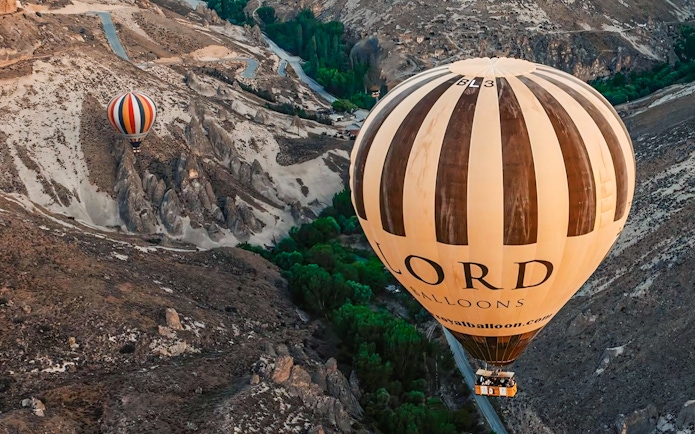 Two hot air balloons floating over Soganli Valley in Cappadocia.