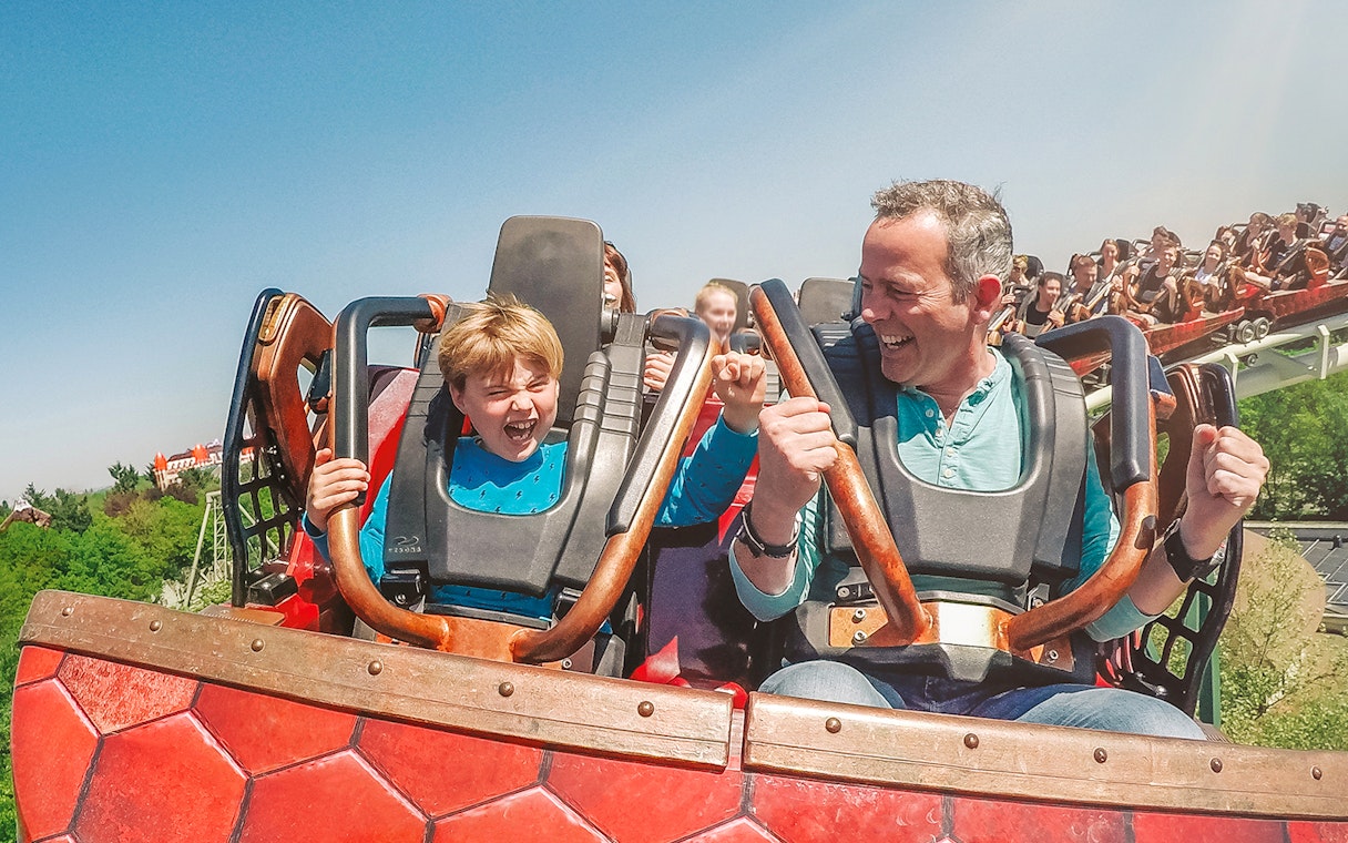 Father and son enjoying a roller coaster ride at Efteling theme park.