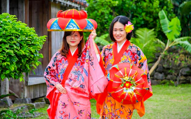Women in traditional Ryukyu attire at Ishigaki Yaima Village, Okinawa.