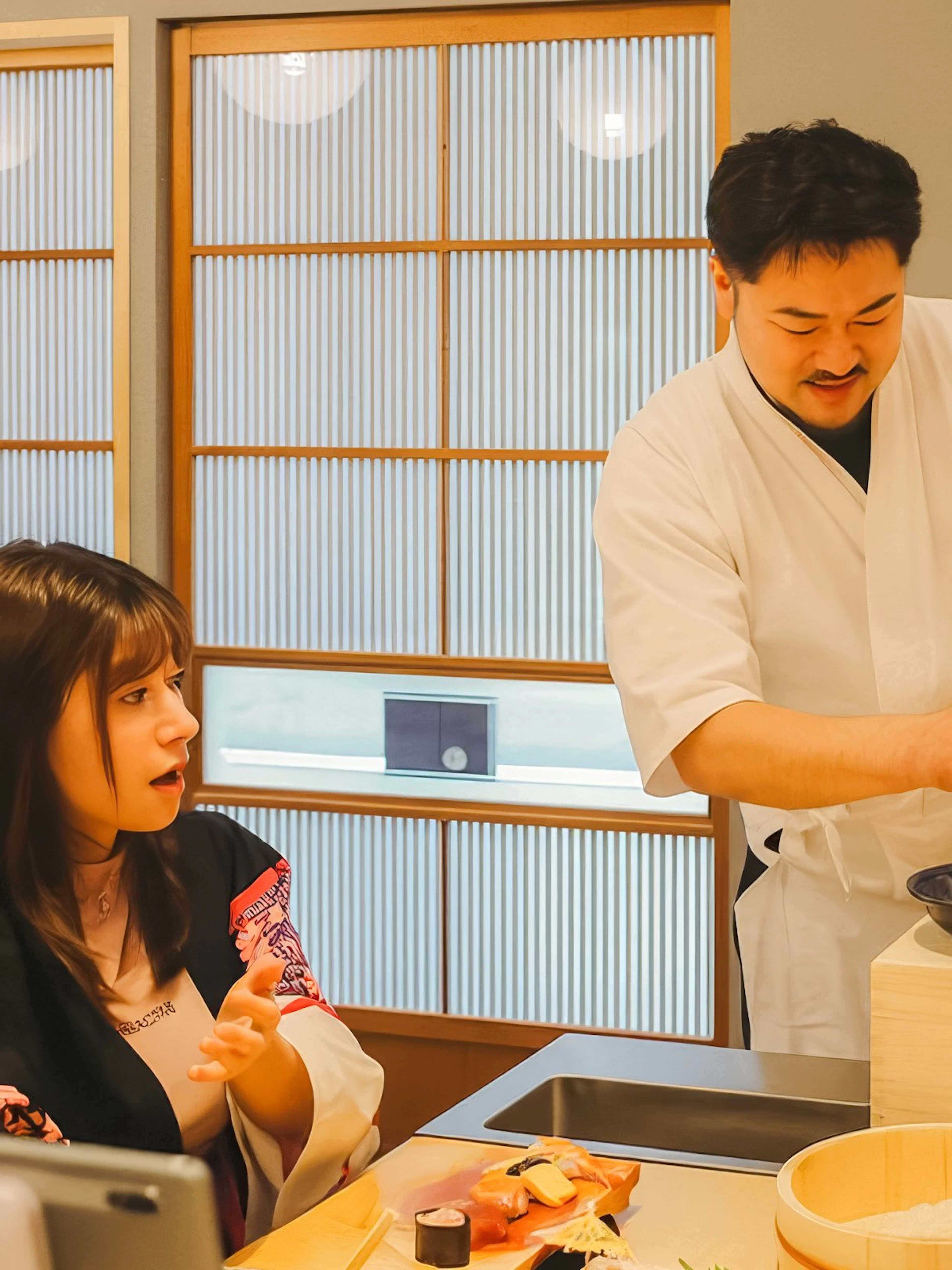 Chef instructing sushi-making class near Tokyo Tower.