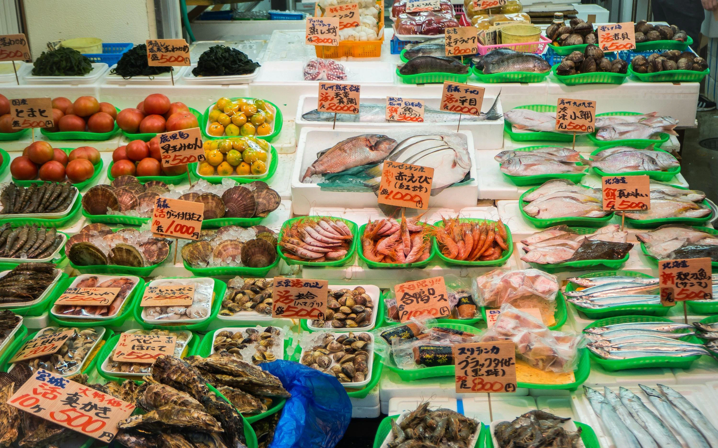 Seafood and produce stall at Ameyoko market street in Tokyo, Japan.