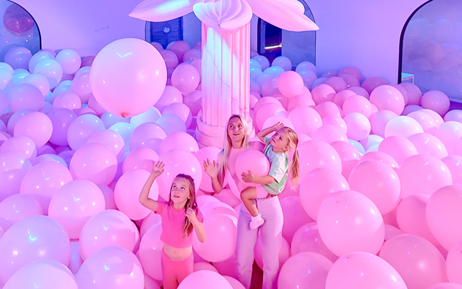 Visitors enjoying pink balloon room at Bubble Planet An Experience Museum.