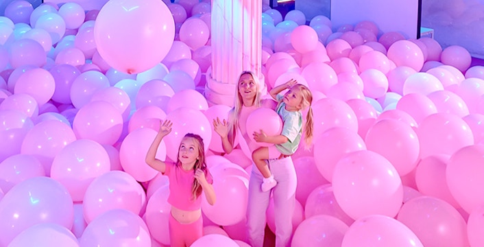 Visitors enjoying pink balloon room at Bubble Planet An Experience Museum.