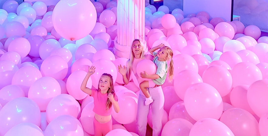 Visitors enjoying pink balloon room at Bubble Planet An Experience Museum.