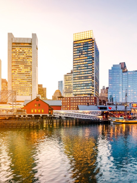 Boston Harbor and Financial District skyline at sunset, Massachusetts, USA.