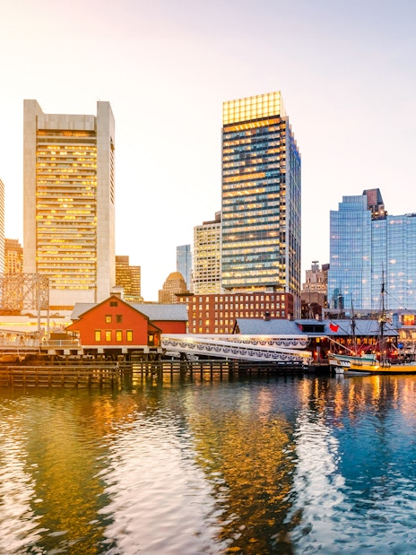 Boston Harbor and Financial District skyline at sunset, Massachusetts, USA.