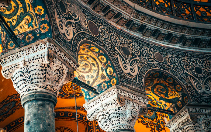 Hagia Sophia interior with ornate columns and intricate mosaics, Istanbul, Turkey.