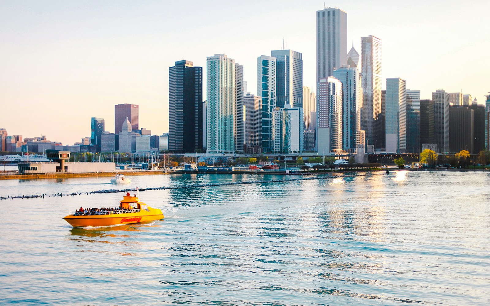 Tourists on Sea Dog Cruise on Lake Michigan with Chicago skyline in background.