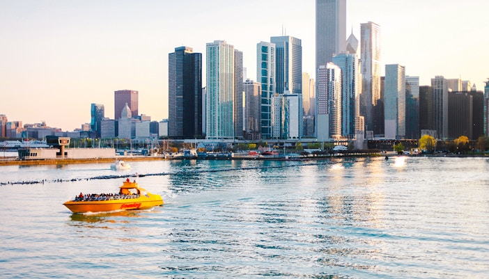 Tourists on Sea Dog Cruise on Lake Michigan with Chicago skyline in background.