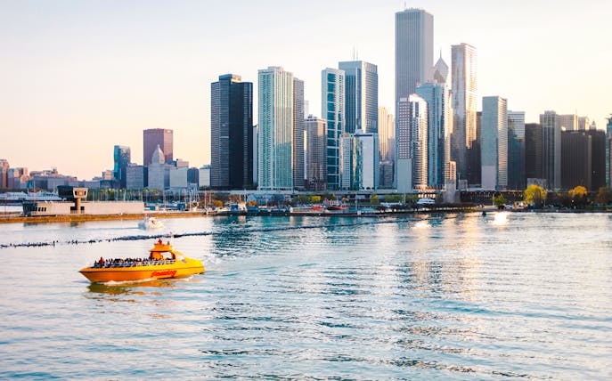 Tourists on Sea Dog Cruise on Lake Michigan with Chicago skyline in background.