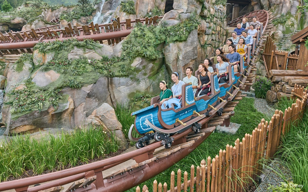 Roller coaster ride at Frozen Ever After, Disneyland Hong Kong, with passengers enjoying the thrill.