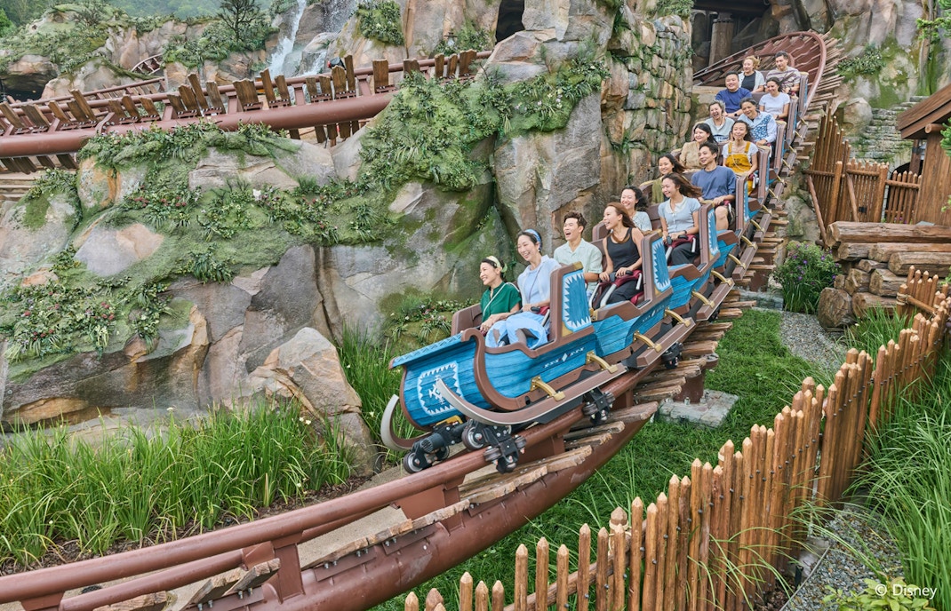 Roller coaster ride at Frozen Ever After, Disneyland Hong Kong, with passengers enjoying the thrill.